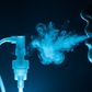 Light with black background, light is light blue, black is dark blue: close up of mouth with smoke next to nebulizer