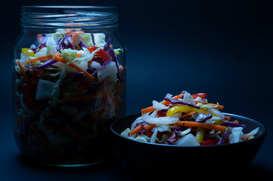 Light with black background, light is light blue, black is dark blue: fermented chopped vegetables in blue and black