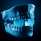 Light with black background. light is light blue, black is dark blue. photo of an upper and lower jawbone with a  jaw exerciser training jaws